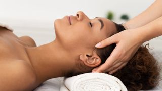 Relaxing Massage. Afro Woman Receiving Head Massage At Spa Salon, Side View