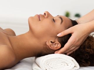 Relaxing Massage. Afro Woman Receiving Head Massage At Spa Salon, Side View