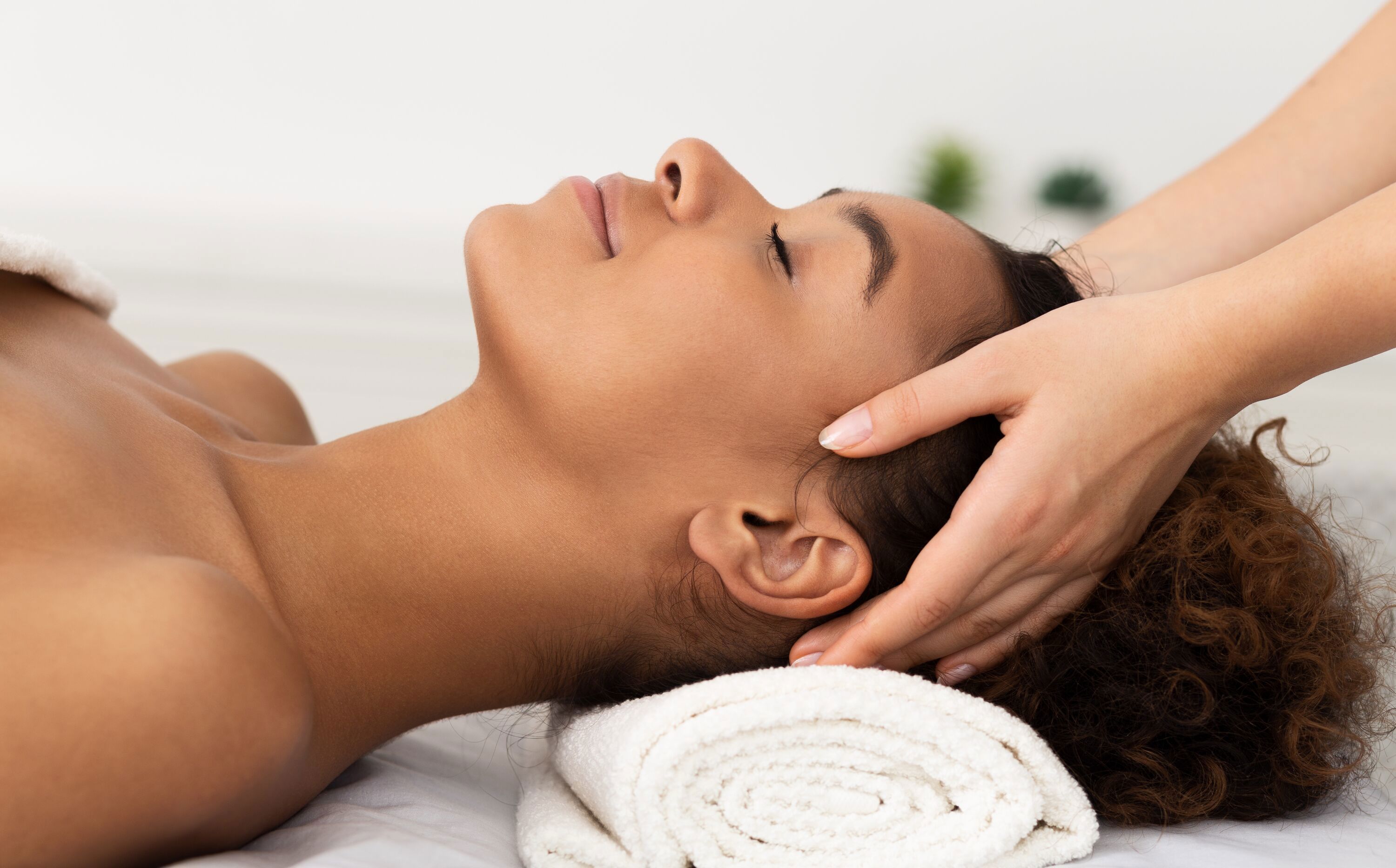 Relaxing Massage. Afro Woman Receiving Head Massage At Spa Salon, Side View