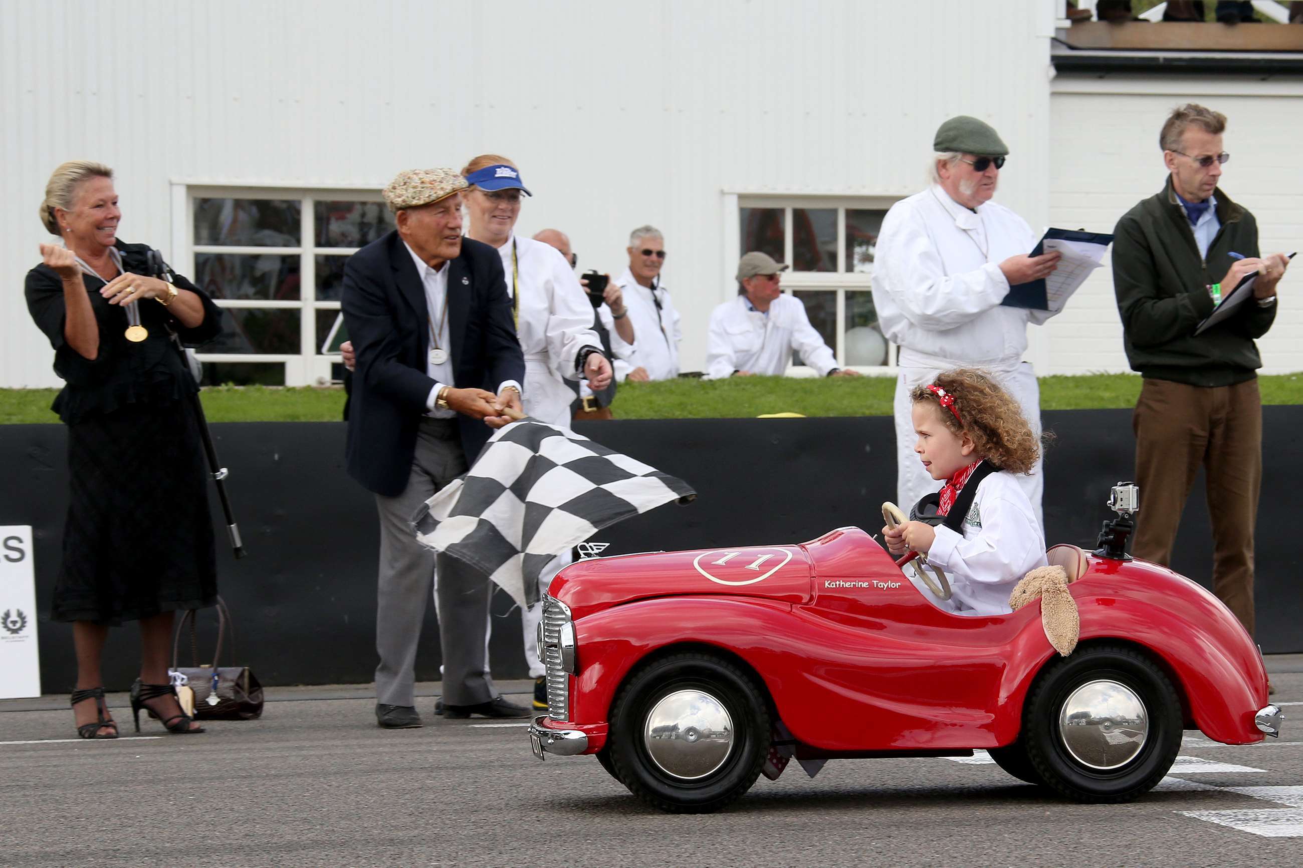Moss waving the chequered flag for the Settrington Cup, Revival 2014.