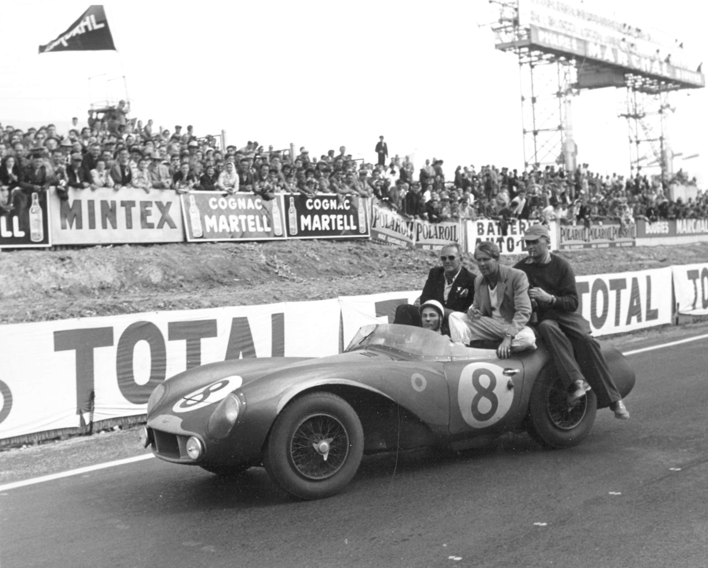1956 Le Mans 24-Hours - 2nd place overall for the works Aston Martin DB3S, Moss driving, with company head David Brown, co-driver Peter Collins and team manager John Wyer behind him.
