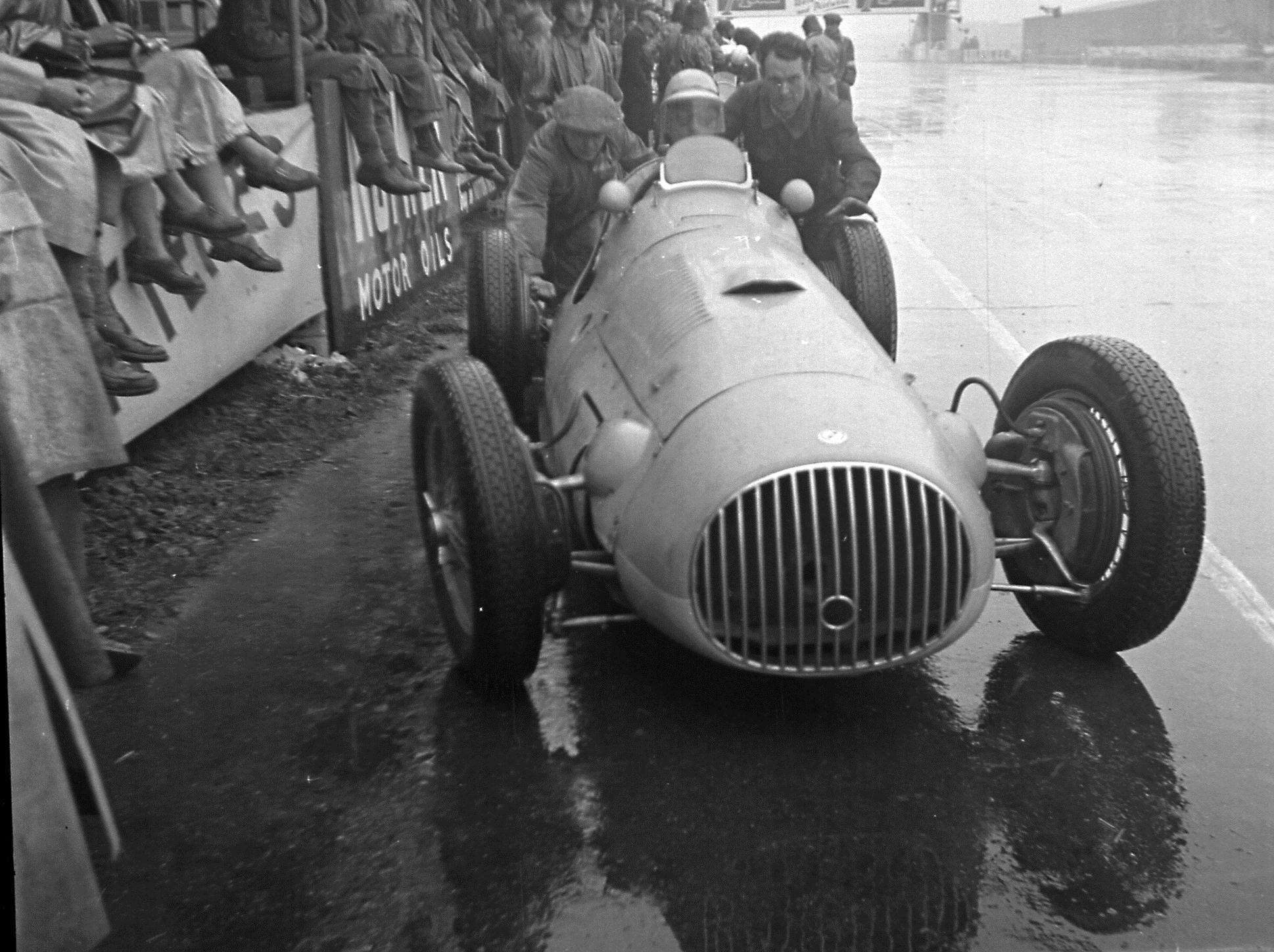 ‘Bira’ in the OSCA V12 being push-started in the rainswept Silverstone pits later in 1951