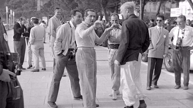 Alberto ASscari (hands raised) - joking with tall and burly Mike Hawthorn (right) while Stirling Moss - first of the super-athletic racing whippet postwar stars - enjoys the moment between them - 1955 Monaco Grand Prix. Sadly, this is one of the last photos ever taken of the great Ascari.