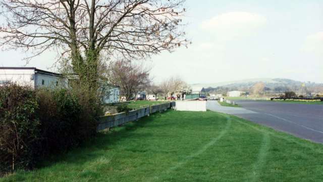 Pitlane and pit area looking back towards the chicane - former race control and press office building to the left - note the old barrier and that tree, still there...