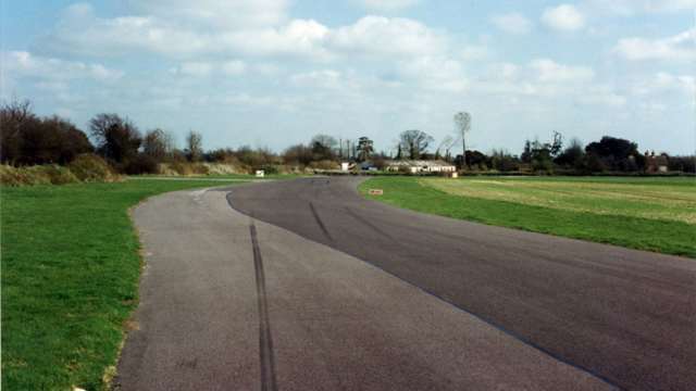 Hurtling into the braking area for Woodcote Corner at the end of the Lavant Straight - the Shell Building an aiming point beyond…