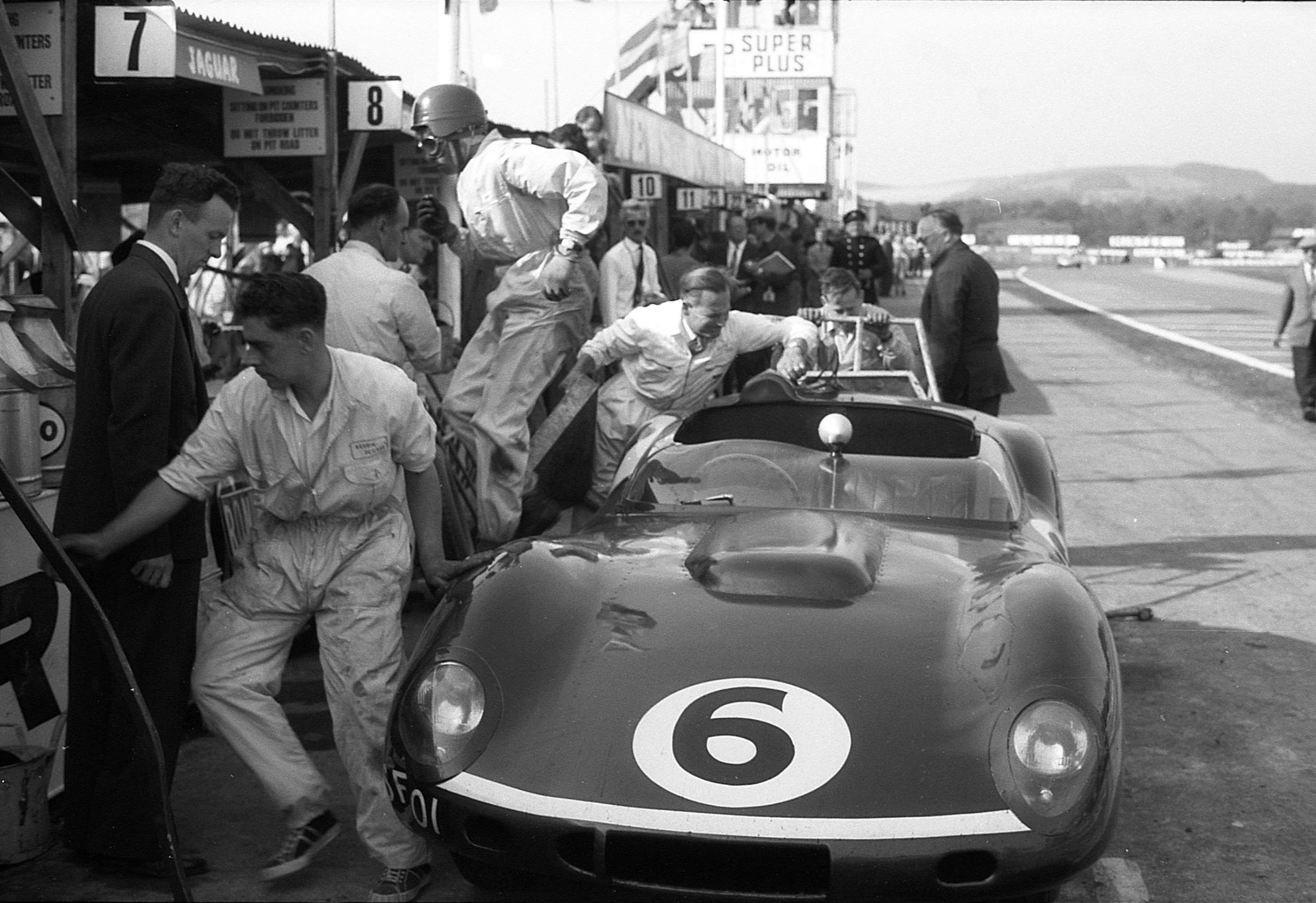 1959 Goodwood TT - Jim Clark vacates the Ecurie Ecosse Tojeiro-Jaguar - the original commentary tower in the background, with its stairs and ladder...
