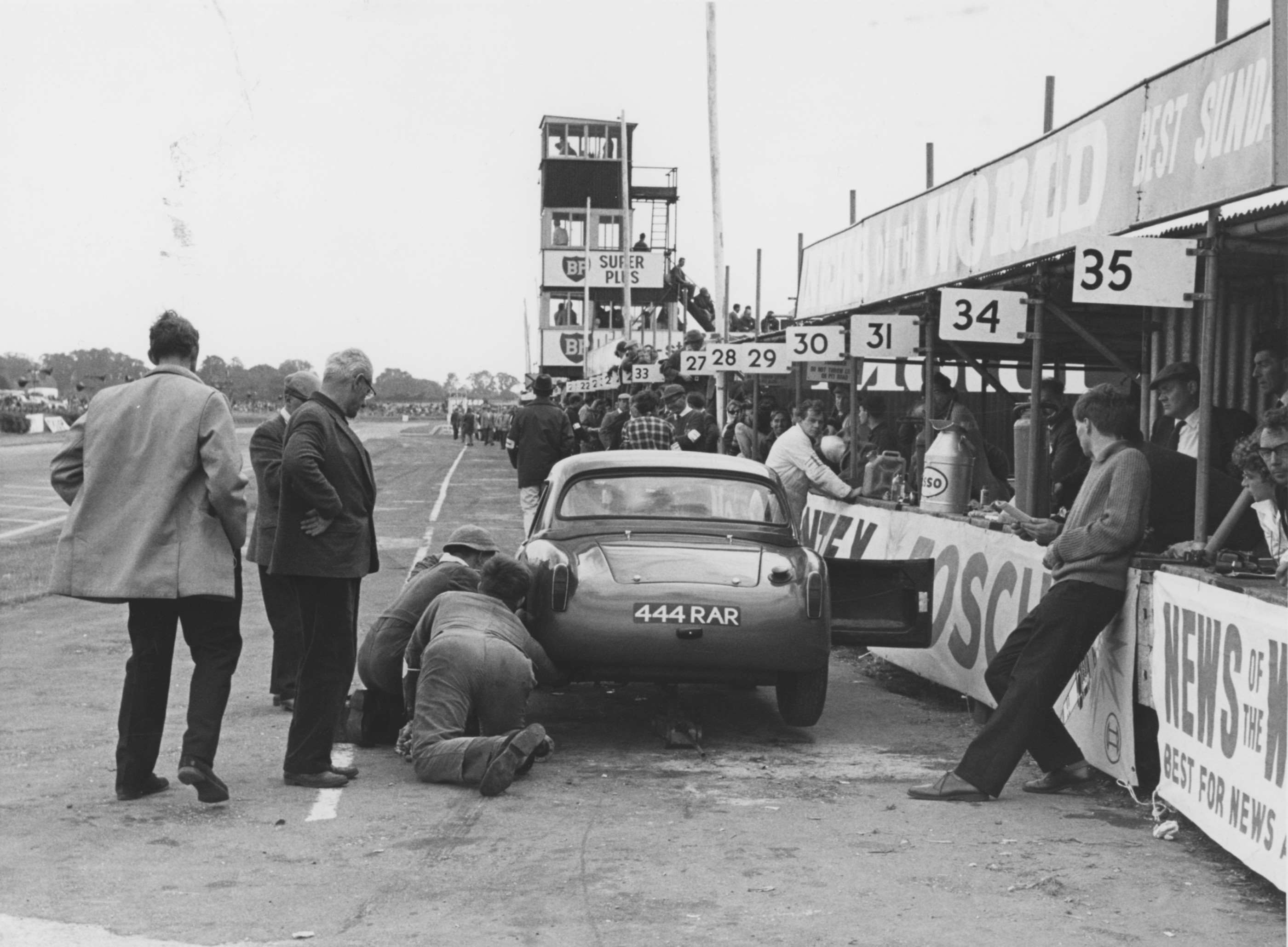 TT Turner in the Goodwood pits early 1960s - the commentary tower beyond with its contemporary stairs and ladders proving useful…
