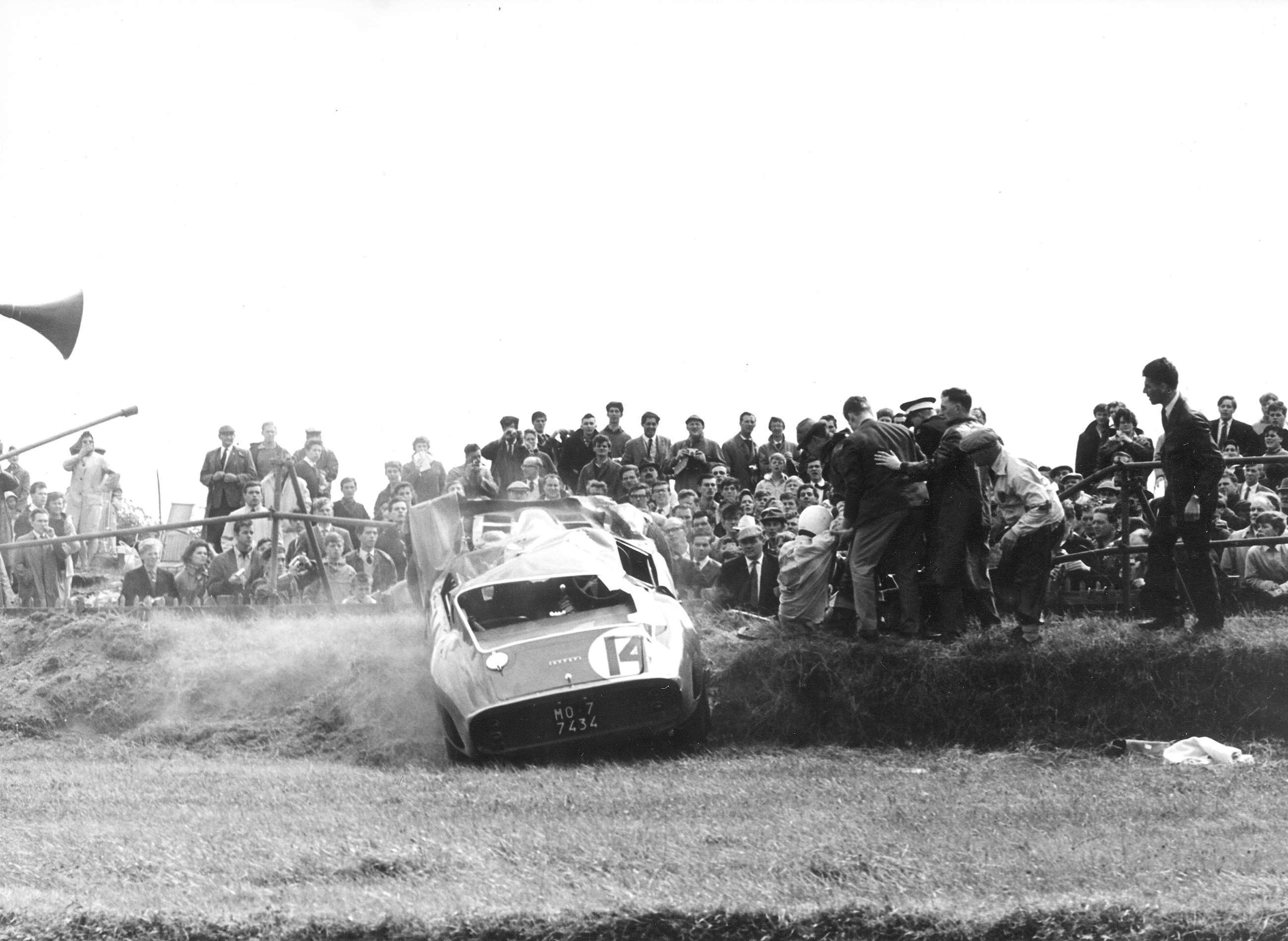 5 - The shaken but hardly stirred Tommy Hitchcock III being helped to his feet post-crash - 1963 Goodwood TT