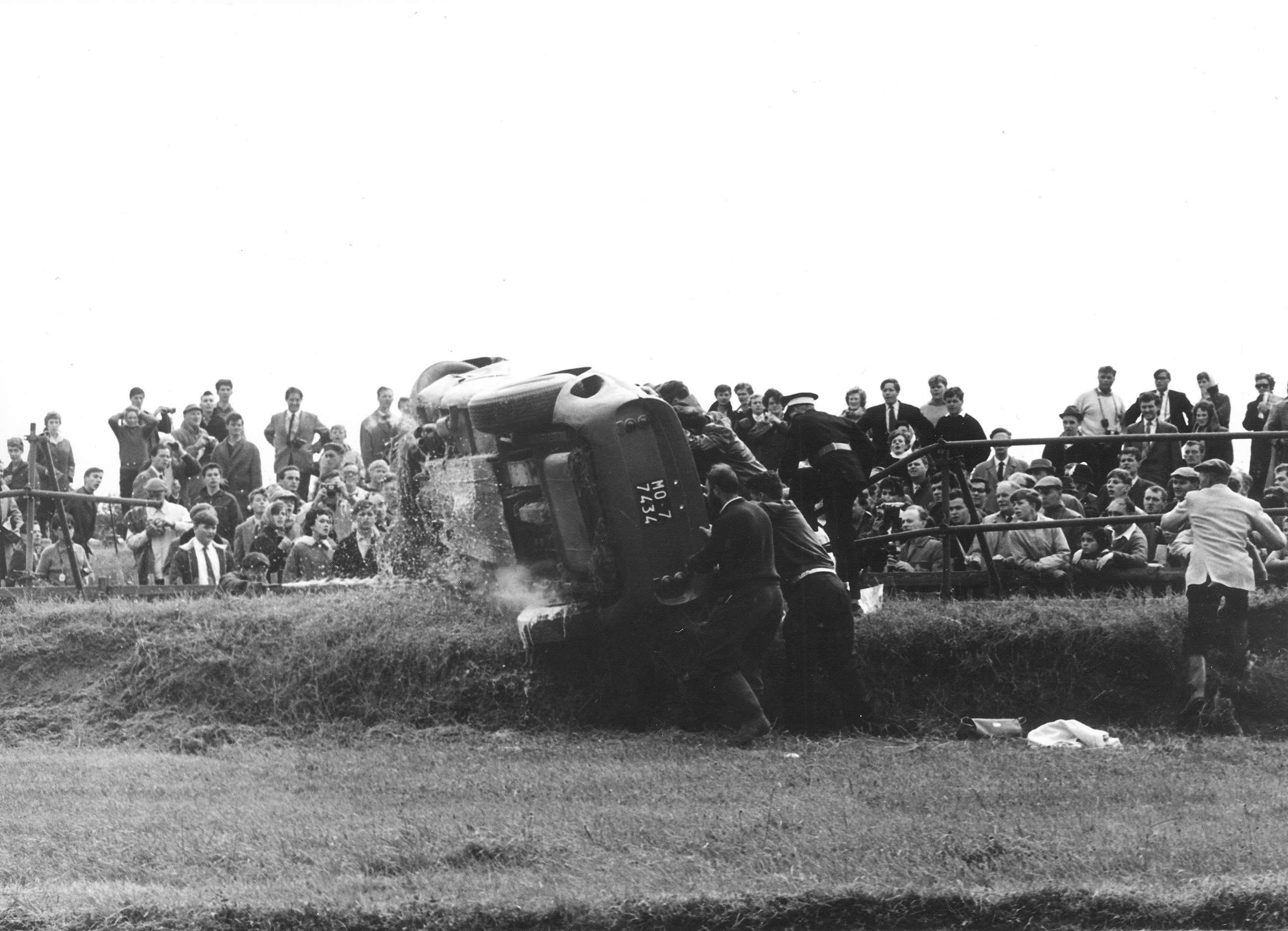 2 - Marshals righting the GTO on the Madgwick bank - 1963 Goodwood TT