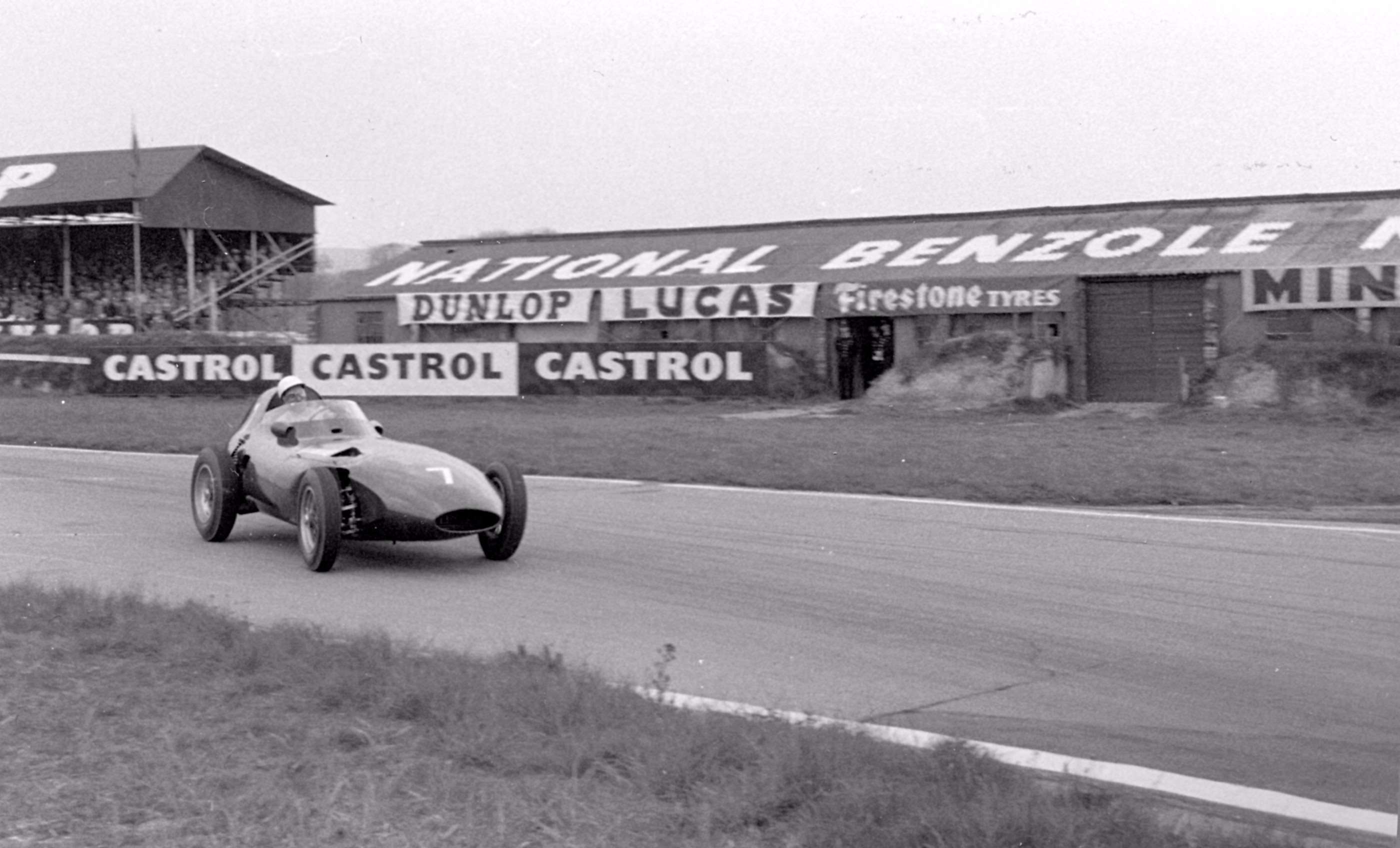 Moss at speed through Woodcote Corner with the 1957 Vanwall’s powerful 4-cylinder engine vibrating away like mad…