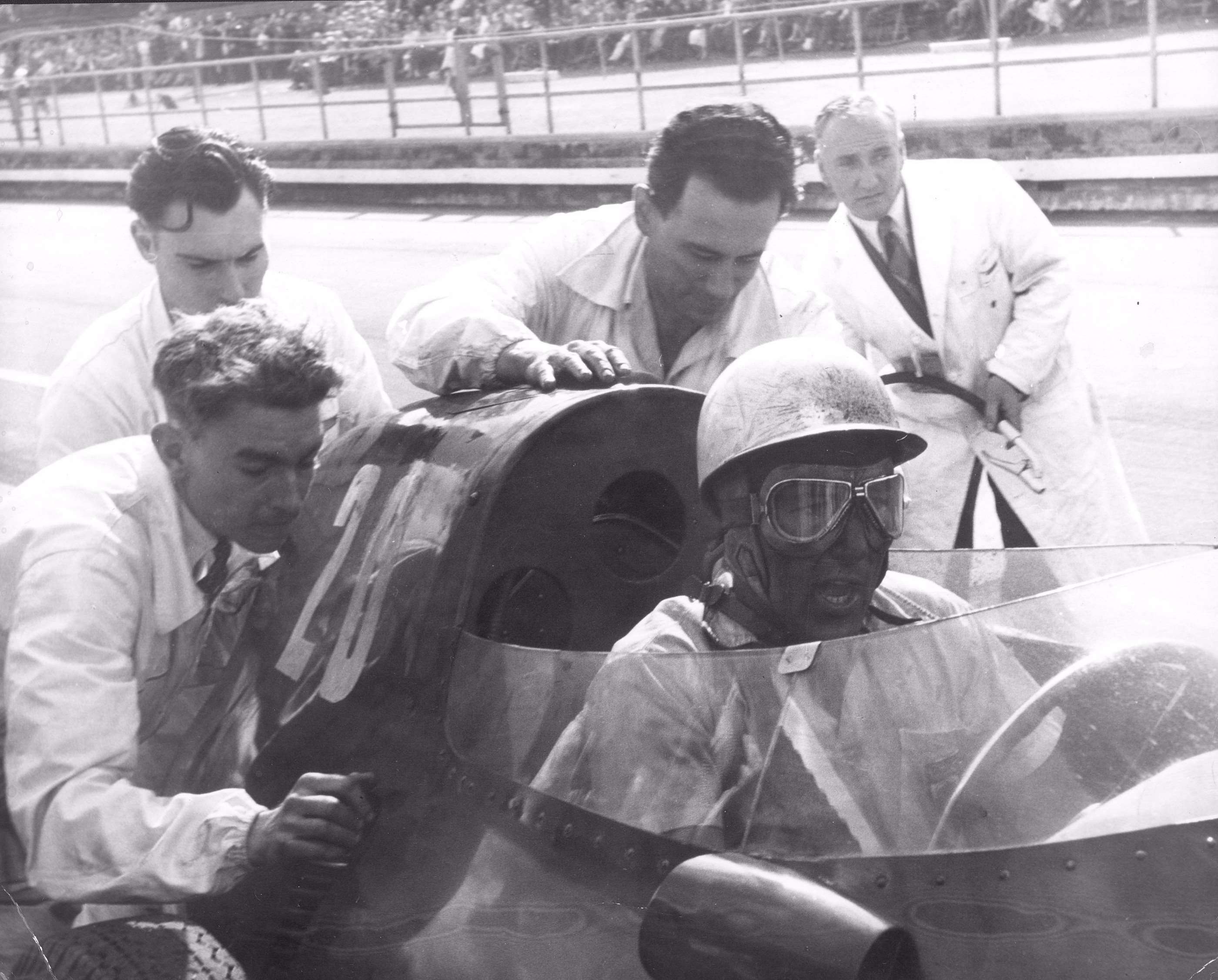 True Tiger! Moss urging on his mechanics to push-start the No 20 Vanwall he had just taken over from Tony Brooks - en route to winning the breakthrough 1957 British GP at Aintree!