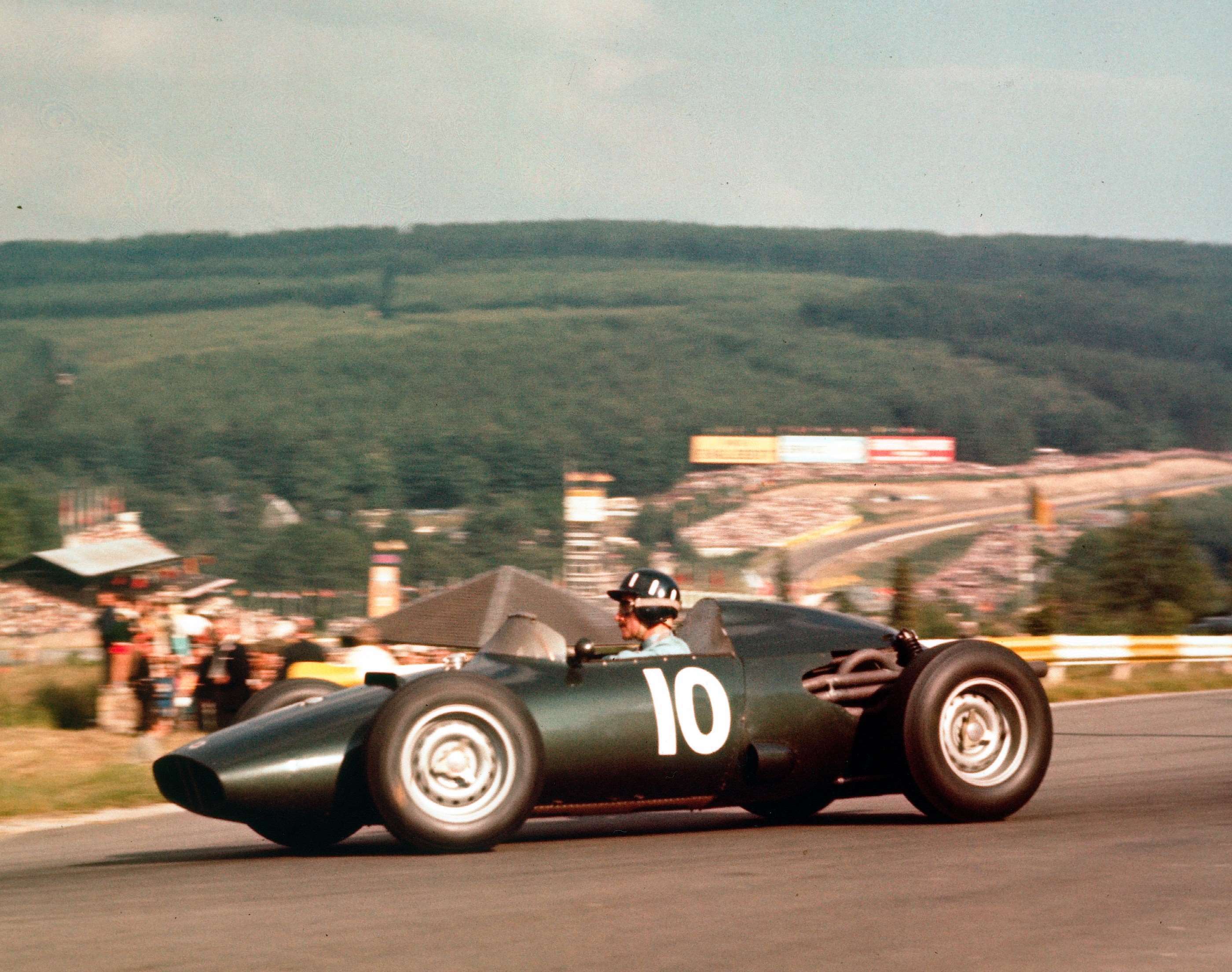 1960 BELGIAN GRAND PRIX - GRAHAM HILL IN THE DEVELOPING REAR-ENGINED BRM P48 AT LA SOURCE HAIRPIN