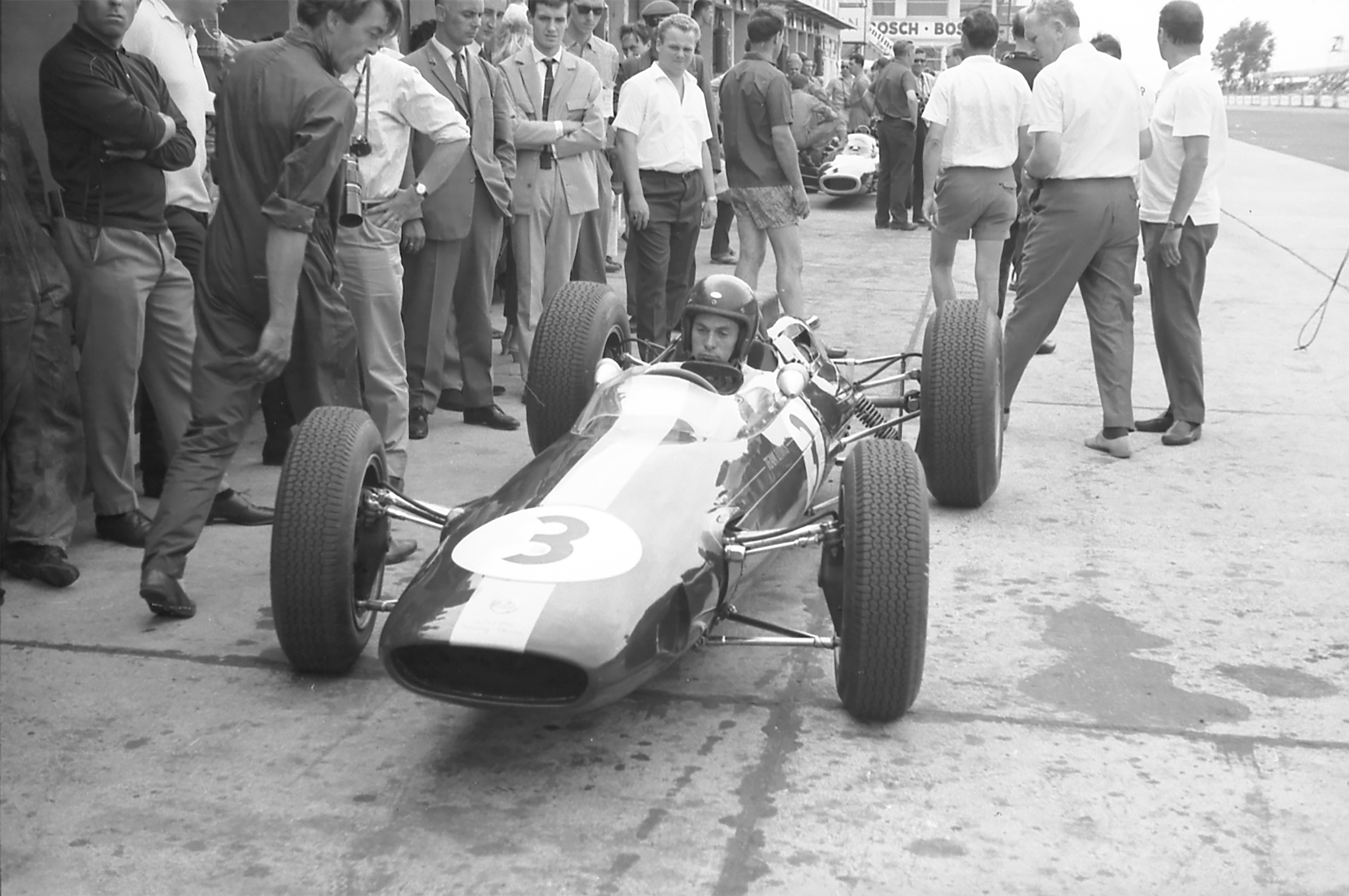 Thoughtful Jim in his works Lotus-Climax 25 just before finishing second to John Surtees’s Ferrari in the 1963 German Grand Prix at the Nurburgring - Jim Endruweit overalled to the left again...