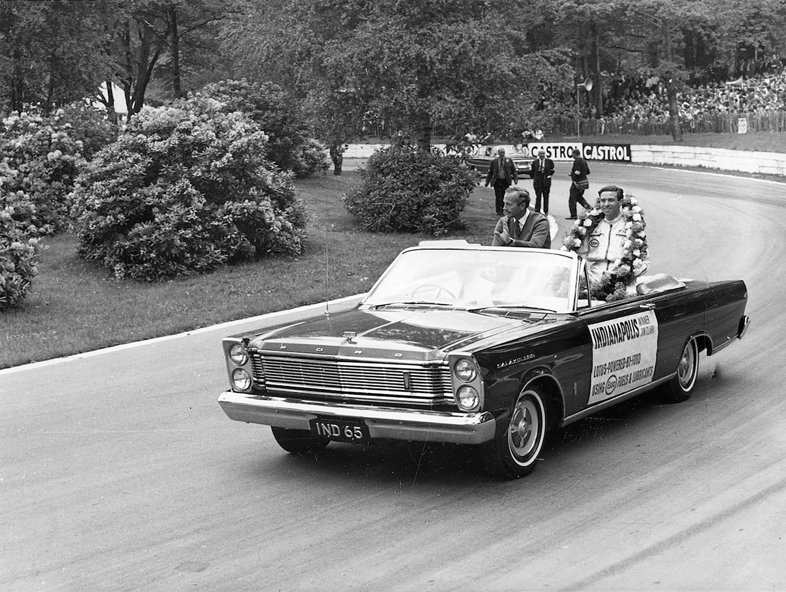 Spoils of victory - Jimmy with Colin Chapman on a tour of honour at the BARC’s Whit-Monday Crystal Palace meeting in their Ford Galaxie 500 convertible after having won the 1965 Indianapolis ‘500’ Miles in the USA. The crowd went barmy...