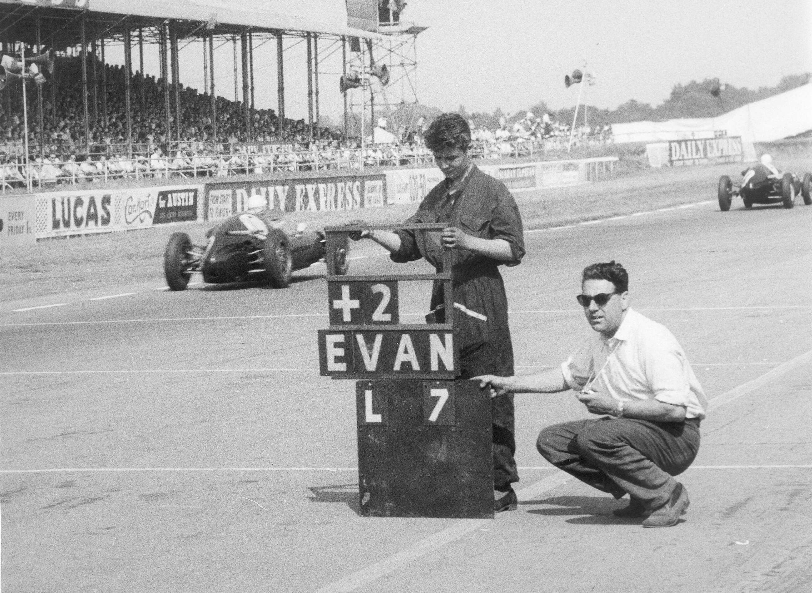 John Cooper signalling his boys as they flash past. Note the ‘pit lane protection’ provided in those days - 60 years ago…