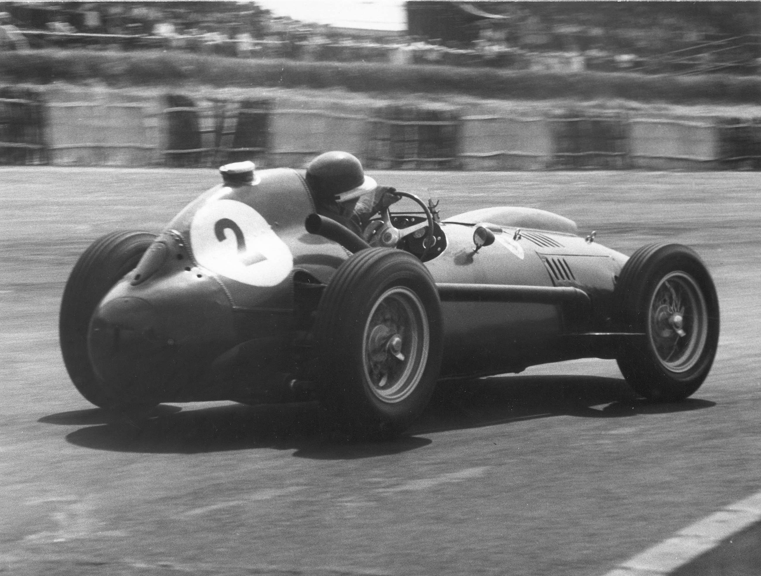 Mike Hawthorn on his way to second place behind his team-mate and great friend Peter Collins - in the 1958 British GP at Silverstone.  The car is the works Ferrari Dino 246 with 2.4-litre 4-cam V6 engine.