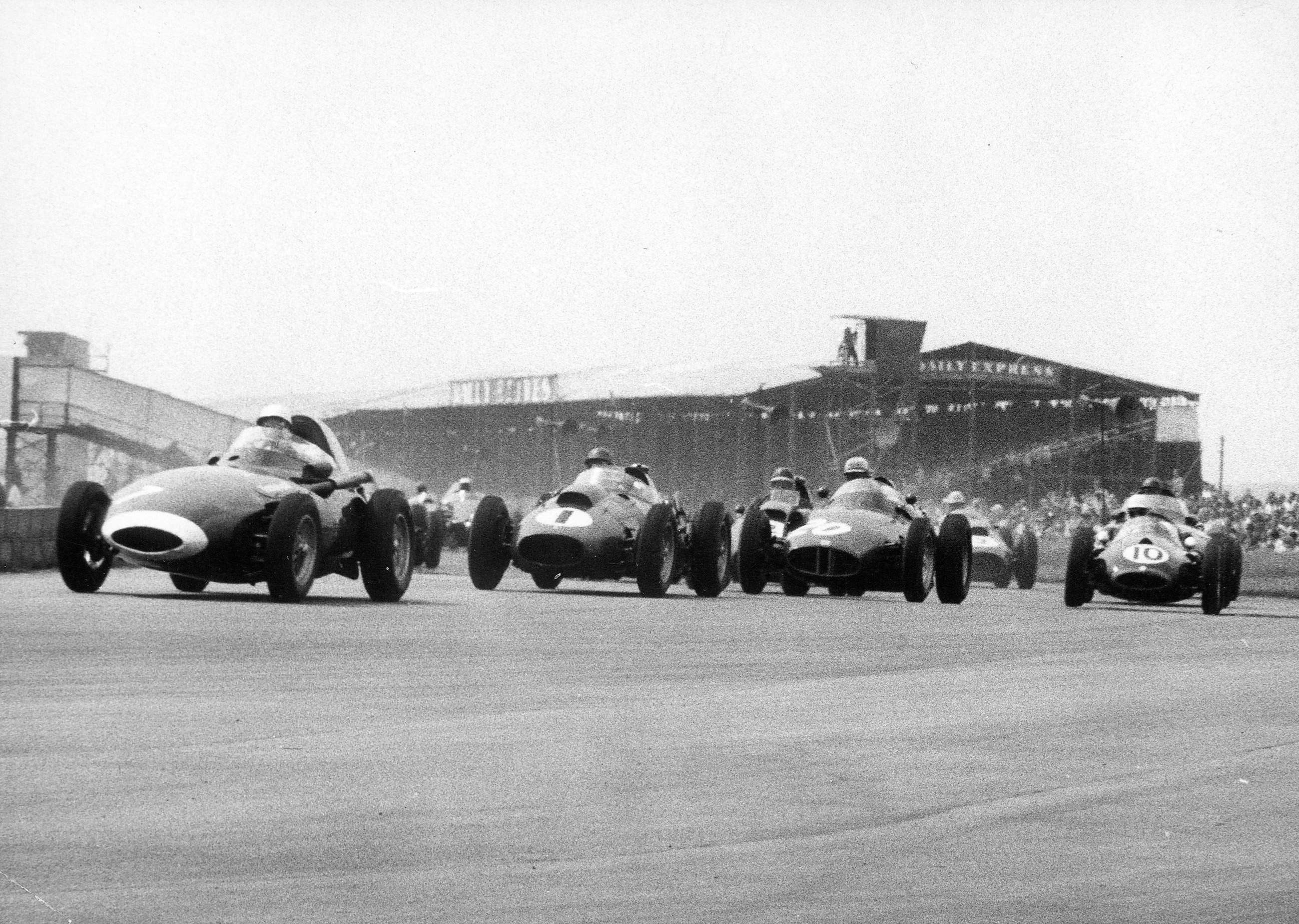 First lap, first corner - 1958 British GP - Stirling Moss leads in the Vanwall from Collins, Harry Schell’s BRM Type 25 (No 20), and Hawthorn. On the outside line is No 10 - Roy Salvadori’s cheeky rear-engined Cooper, which will finish 3rd behind the works Ferraris. Here was the future...