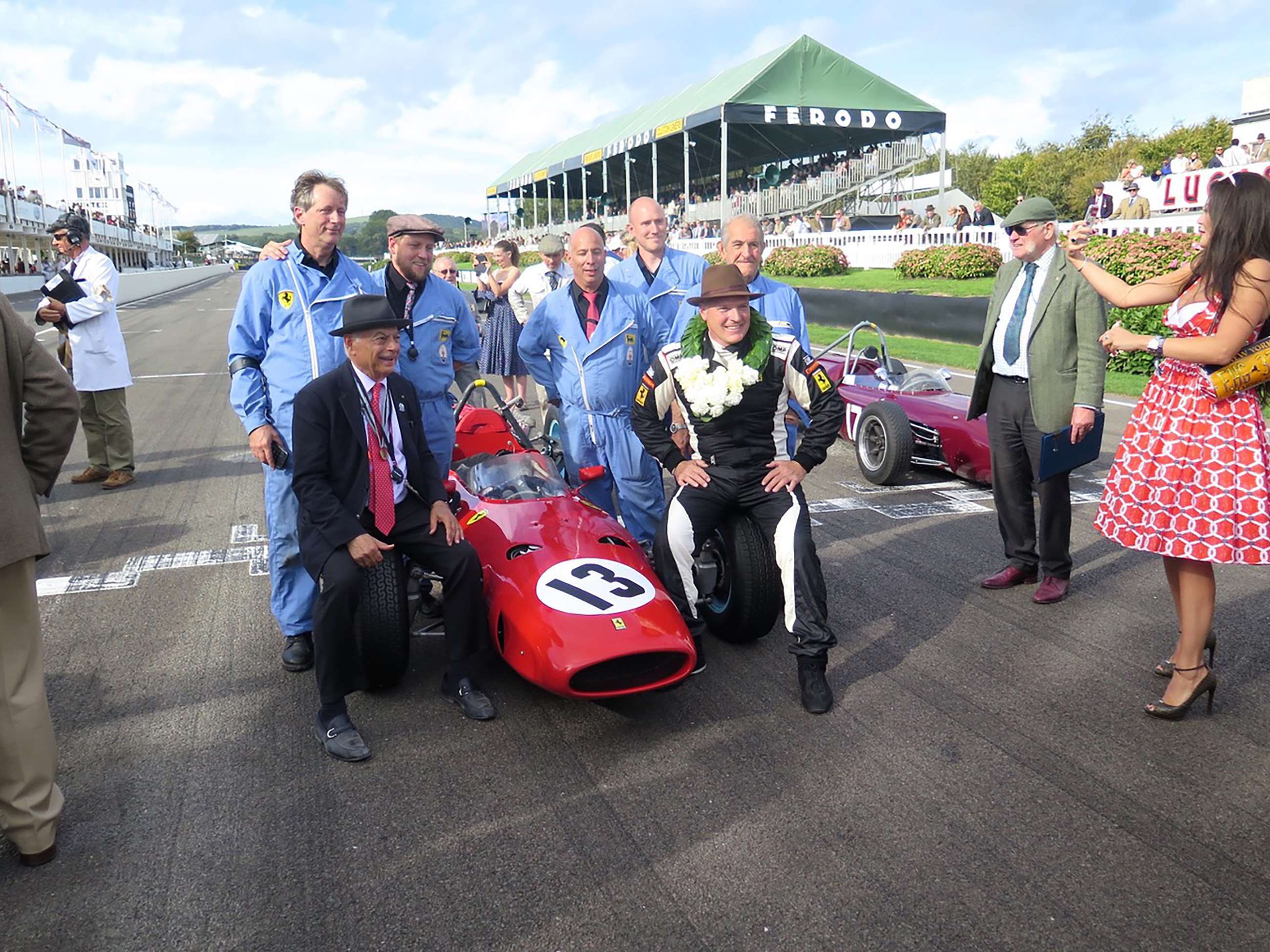 Team celebration after winning the Goodwood revival 2018 Glover Trophy race - on the front wheels owner Laurence Auriana and driver/engineer Joe Colasacco