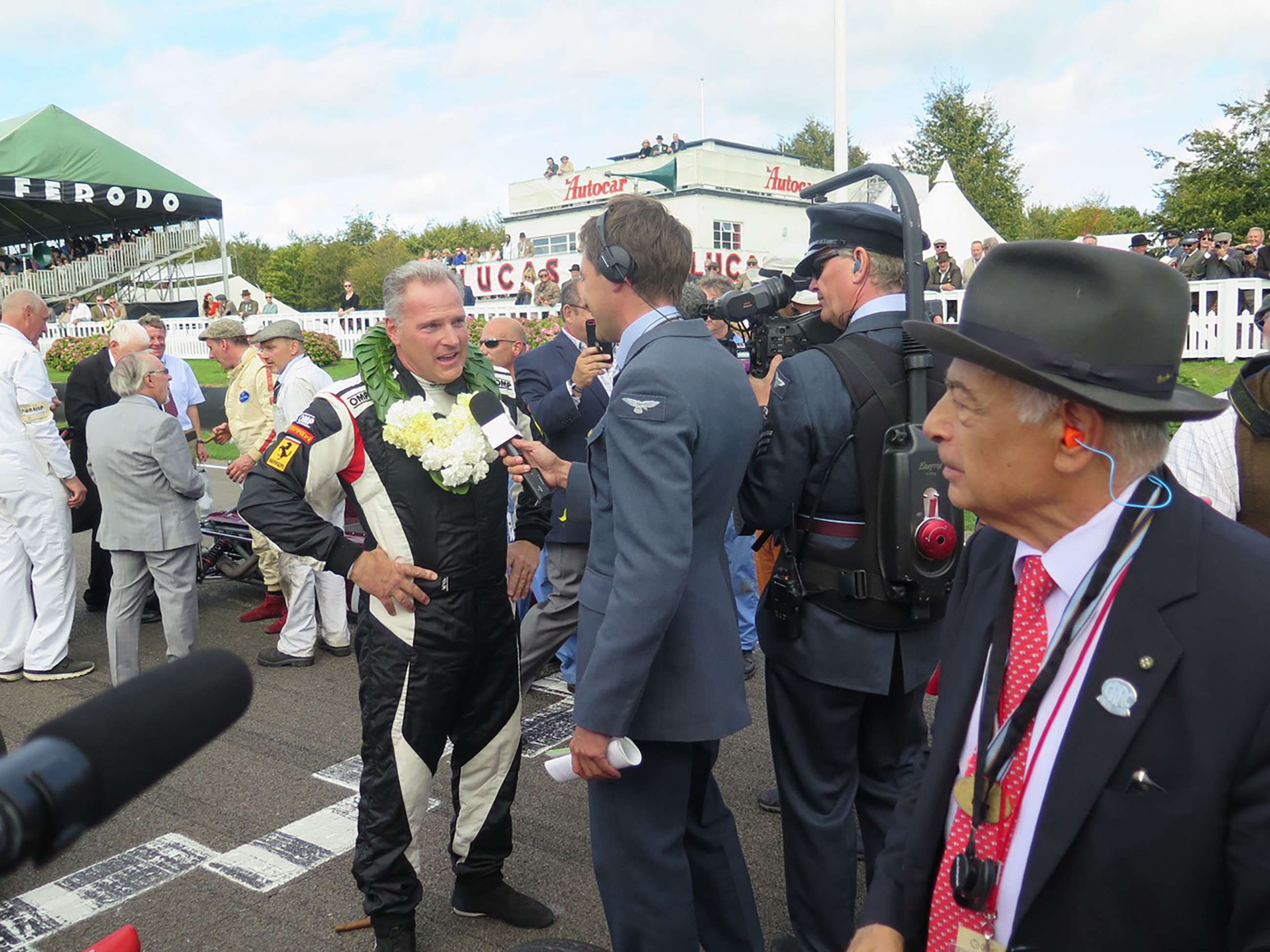 Job finally done - Joe Colasacco being interviewed on th finish line just after winning the Revival Glover Trophy 2018 – shell-shocked but immensely satisfied car owner Larry Auriana right...