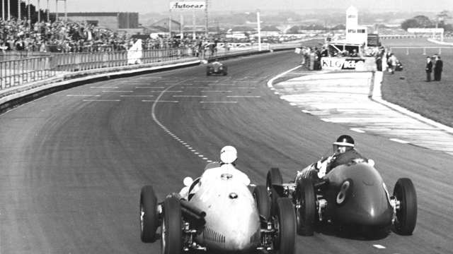 Typical Mike - turning round to grin at Harry Schell from his Vanwall cockpit, Aintree 1955.