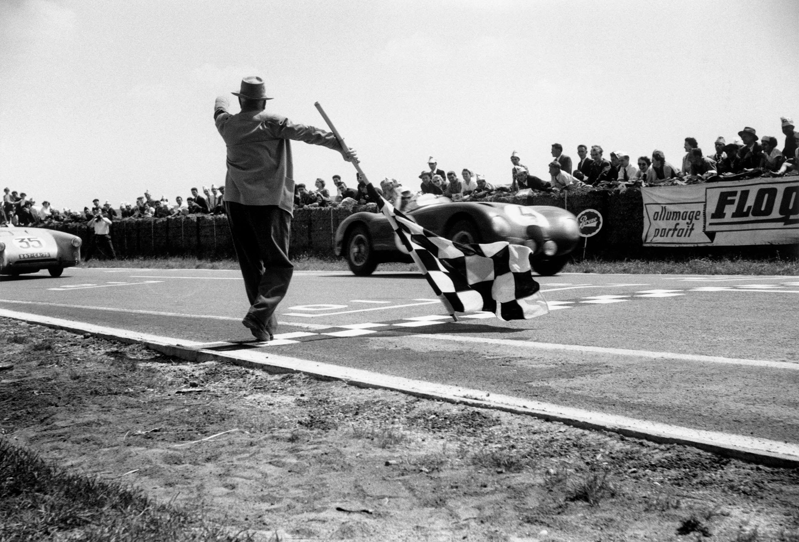 Moss winning at the wheel of a Jaguar C-Type at Reims in 1953, one year after winning with the disc-braked C-Type for the very first time. 
