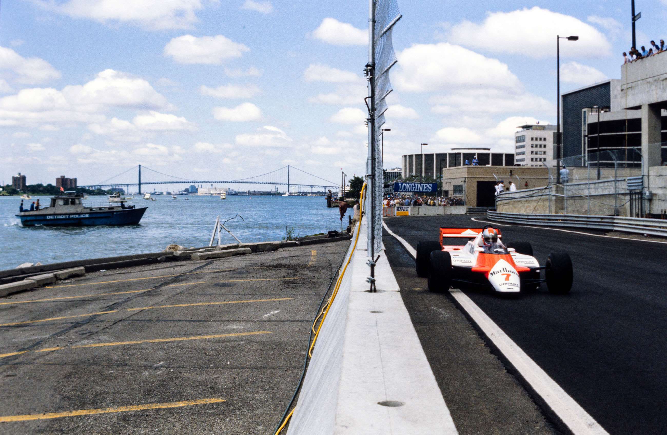 Watson speeding through the streets of Detroit, 1982. The nearby police boat does not issue a ticket. 