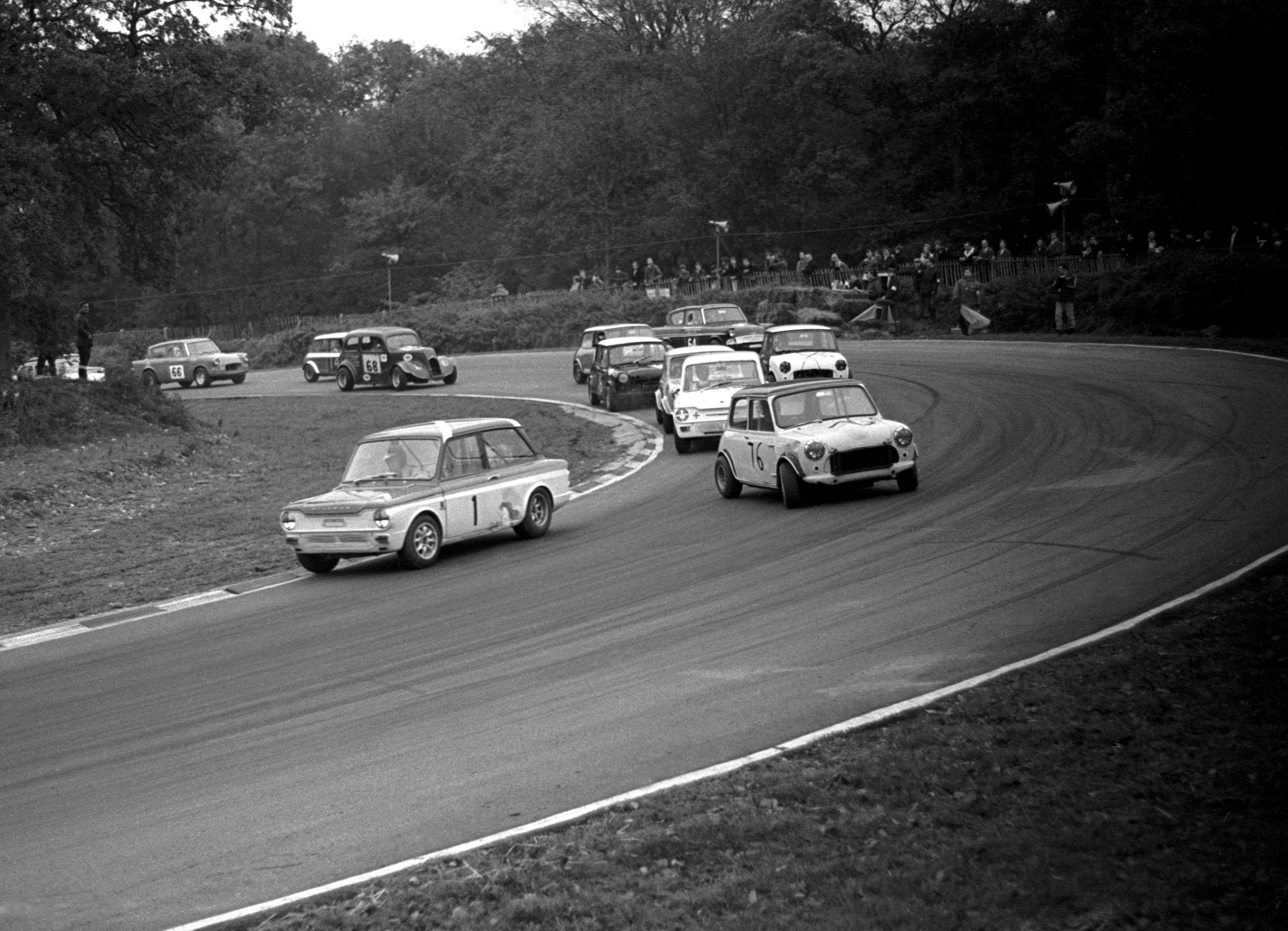A Saloon Car Club Racing meeting at Brands Hatch, 1969. A Sunbeam Imp leads a Mini that, quite clearly, is having a little moment...