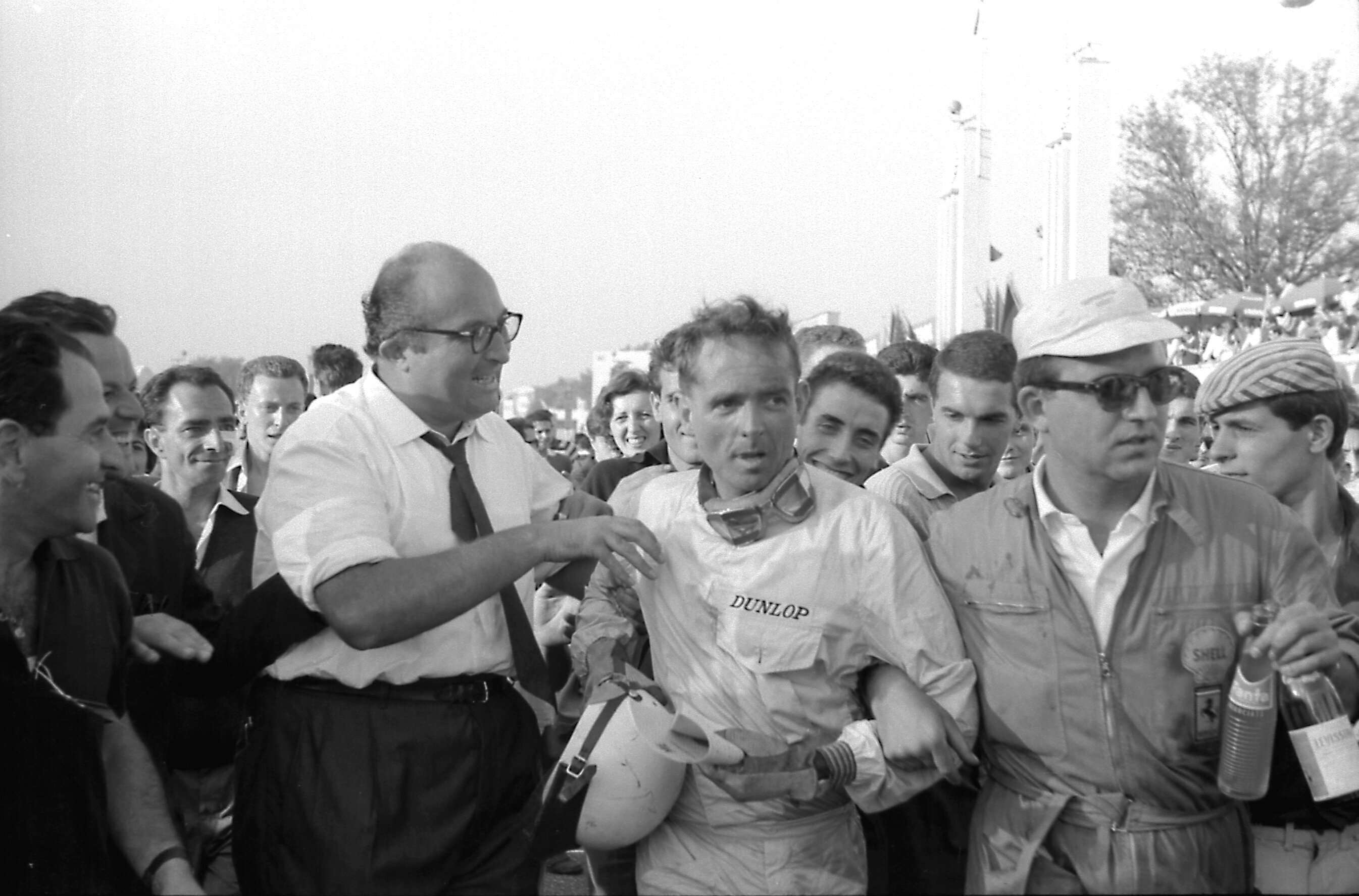 New World Champion Phil Hill immediately after his Italian GP victory – but Ferrari chief engineer Carlo Chiti (left) is trying to tell him something…