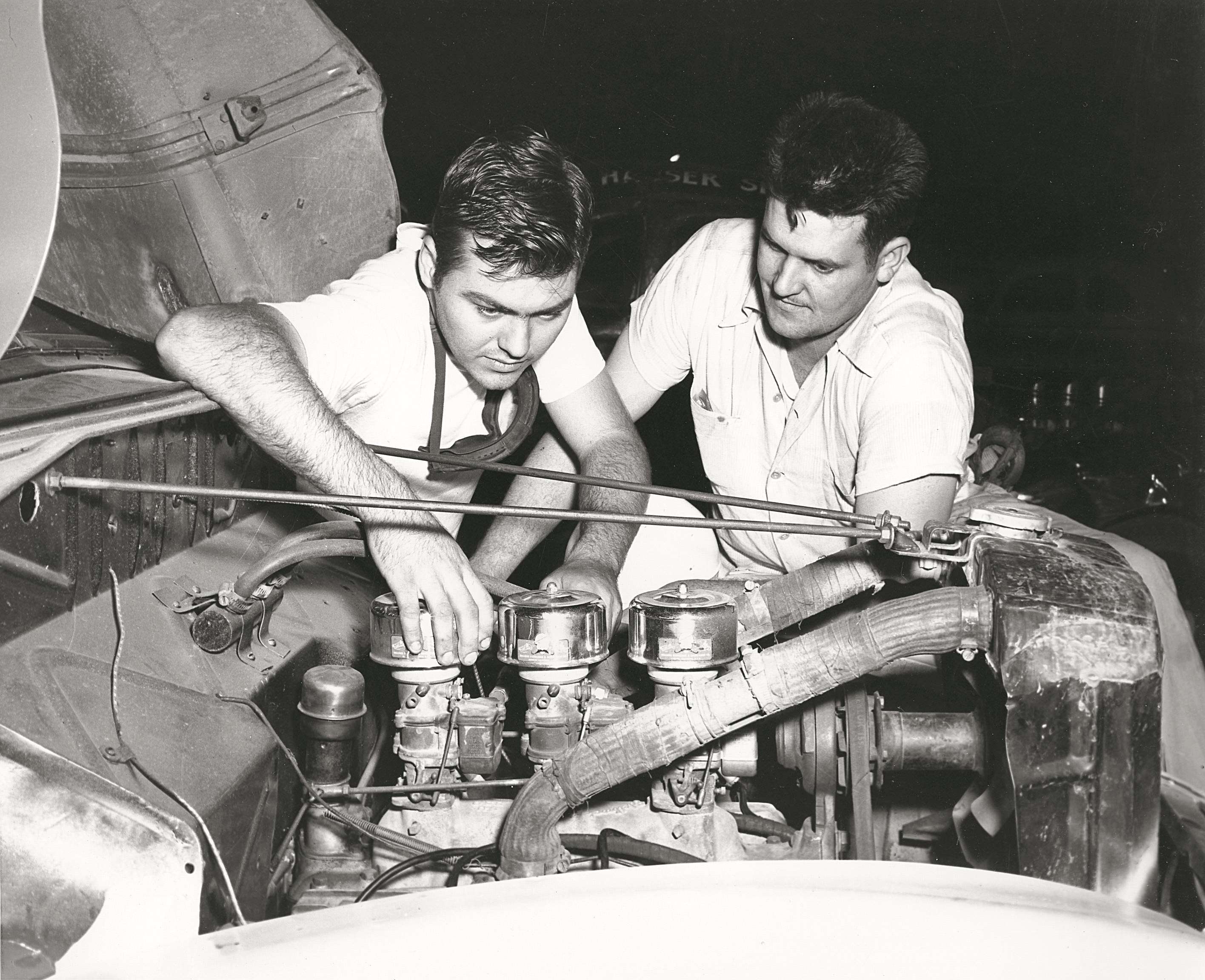 Junior Johnson, left, helps tune a souped-up car used to deliver moonshine